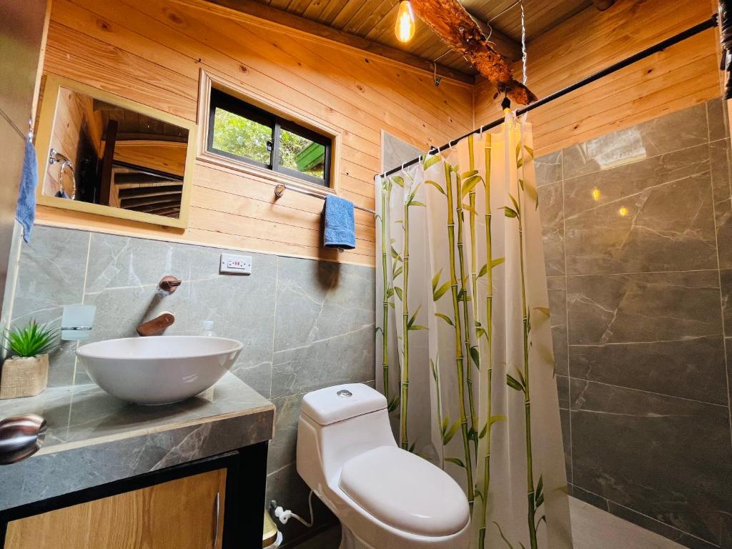 a bathroom with a toilet and a sink at Monte Santa Elena in Medellín