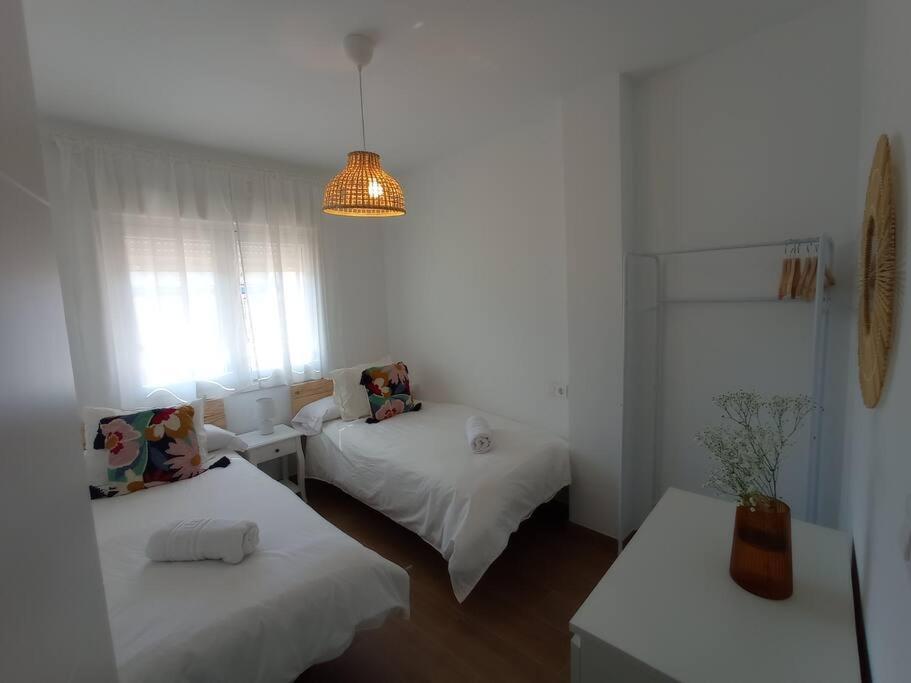um quarto branco com 2 camas e uma janela em Apartamento cerca de Granada em Cenes de la Vega