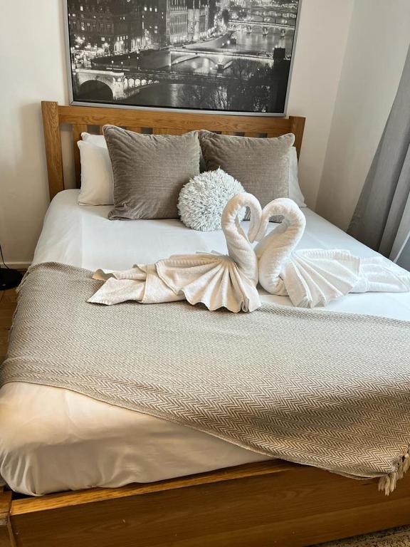 Hotel 1 Bedroom property in East London, two swans are sitting on top of a bed at 1 Bedroom property in East London in London