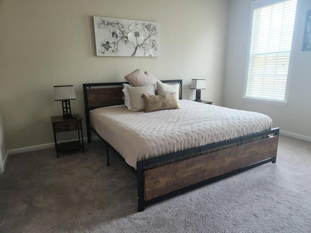 a bedroom with a bed with pillows on it at Emma Blue in Collierville