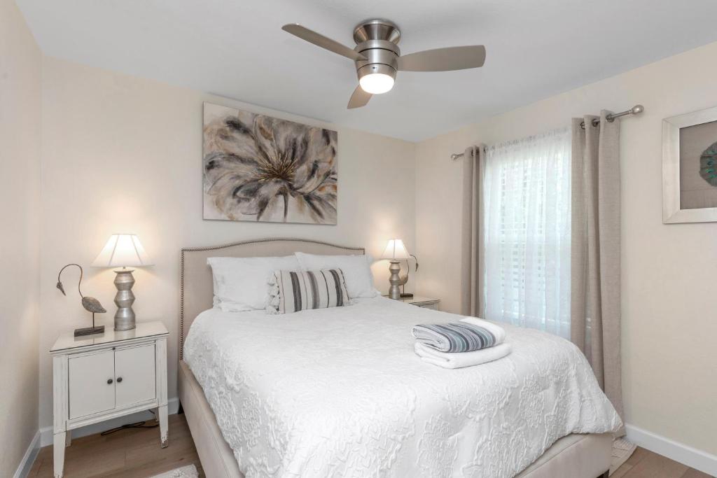 a white bedroom with a bed and a ceiling fan at Gulf Breeze Home/Remodeled 2Bdr in Gulf Breeze