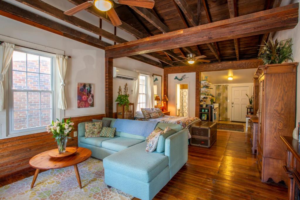 a living room with a blue couch and a table at Stella Blue - 8 in Savannah