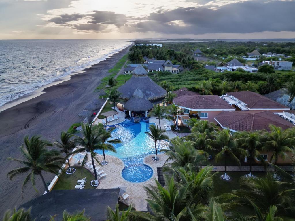 an aerial view of the resort and the beach at Hotel Cayman Suites in Monterrico