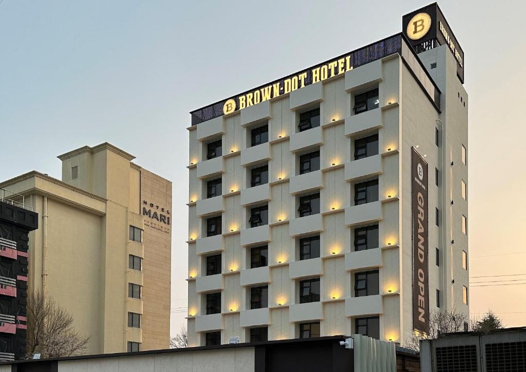 a hotel building with a sign on top of it at Browndot Hotel Jeonju Ajung in Jeonju