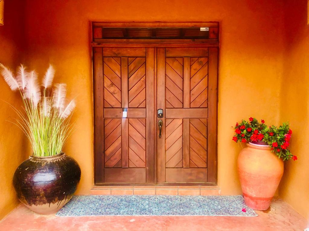 two vases sitting in front of a door at Celestial Casita in Colorado Springs