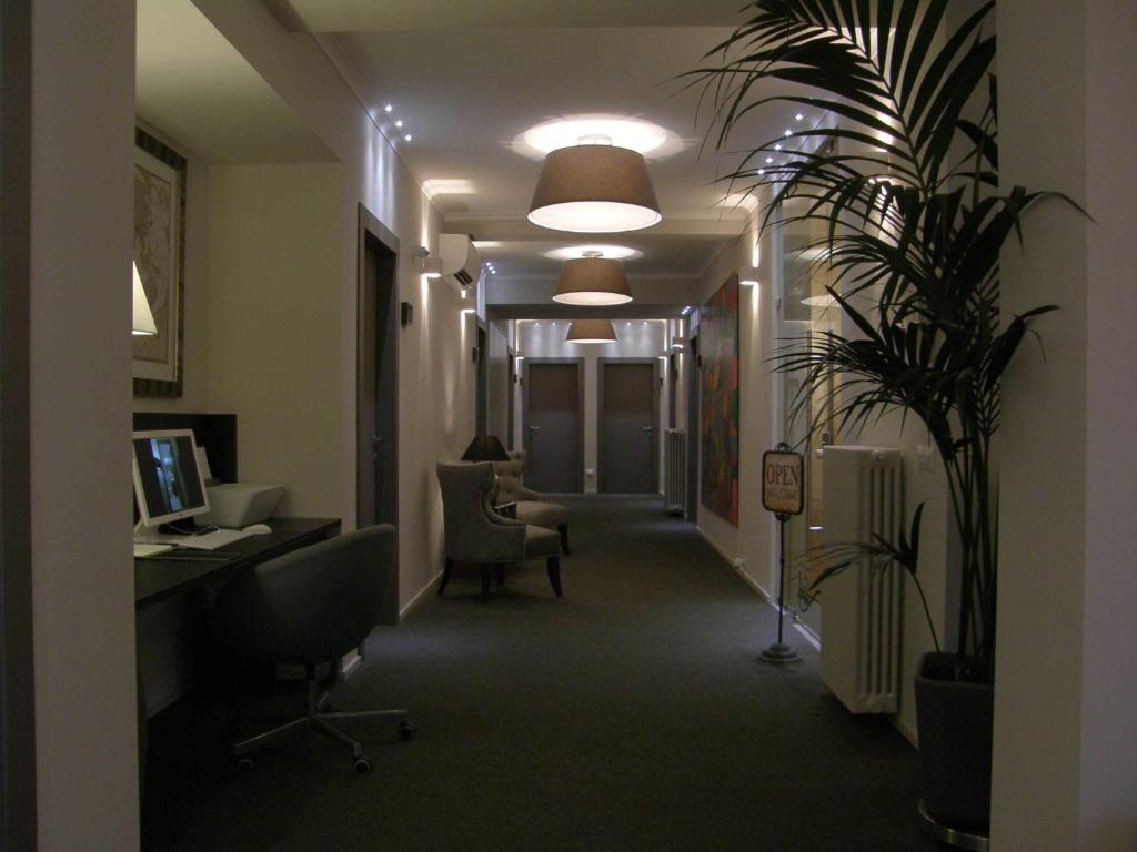 an office hallway with a desk and a plant at Zuretti 61 in Milan