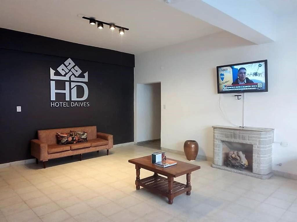 a living room with a tv and a fireplace at Hotel Daives in Termas de Río Hondo