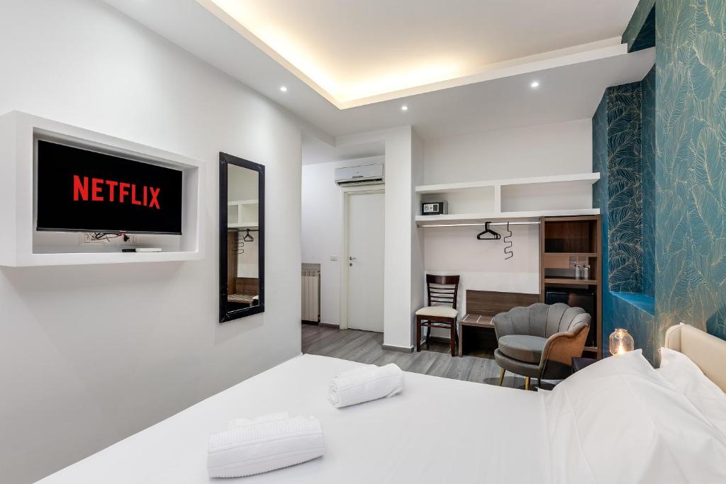 a hotel room with a bed and a living room at Spagna Boutique Suites in Rome