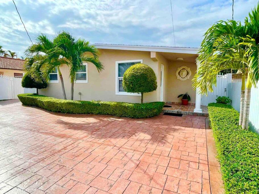 a house with palm trees and a brick driveway at Executive House Miami, Close to Airport, Beach in Miami