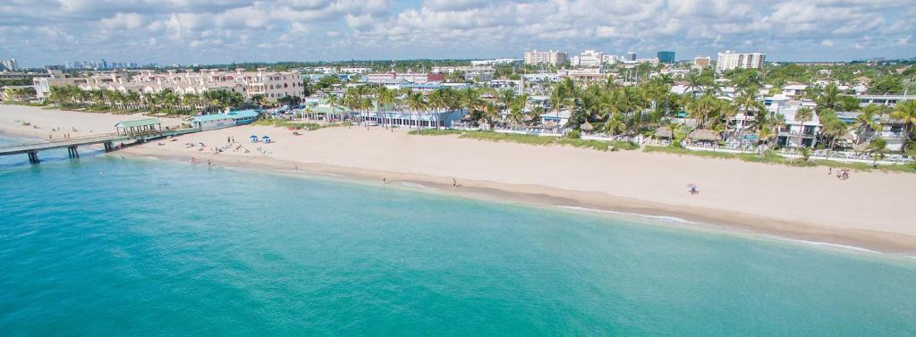 an aerial view of a beach with a pier at Life is Blue in Fort Lauderdale