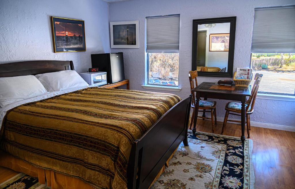 a bedroom with a large bed and a table with chairs at Cypress Fairway Village in Wimberley