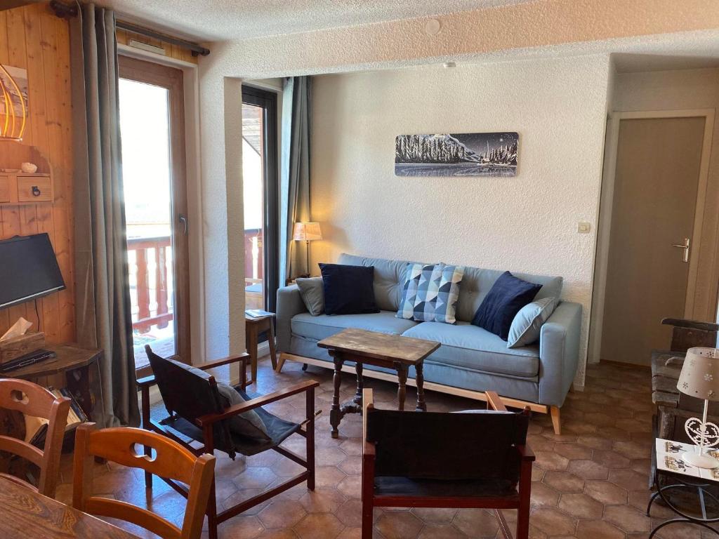 a living room with a couch and a table and chairs at Appartement Valloire, 3 pièces, 5 personnes - FR-1-263-530 in Valloire