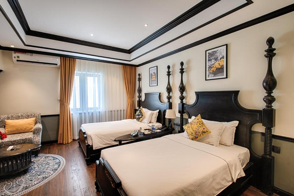 Voodi või voodid majutusasutuse Monarque Hotel Danang toas