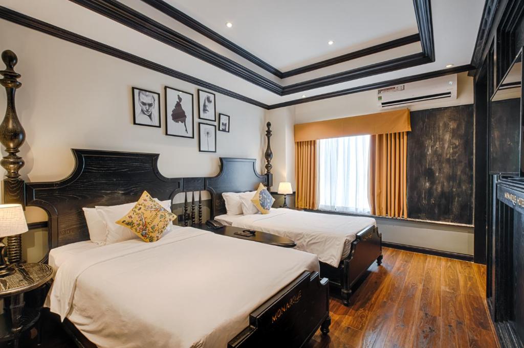 Voodi või voodid majutusasutuse Monarque Hotel Danang toas