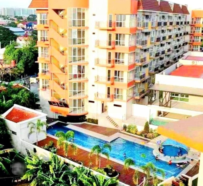 an aerial view of a building with a swimming pool at The Lancris Residences, 2 Bedrooms, 1 Bathroom, Livingroom & Kitchen Pool is free! in Manila