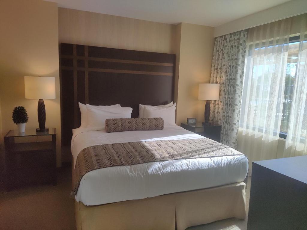 a bedroom with a large bed and two lamps at 1 bedroom condo F1 / Superbowl Availability in Las Vegas