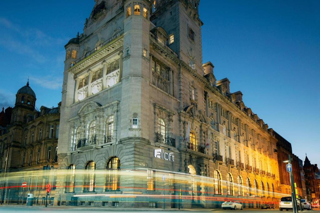 a large building with a sign on the side of it at Aloft Liverpool in Liverpool