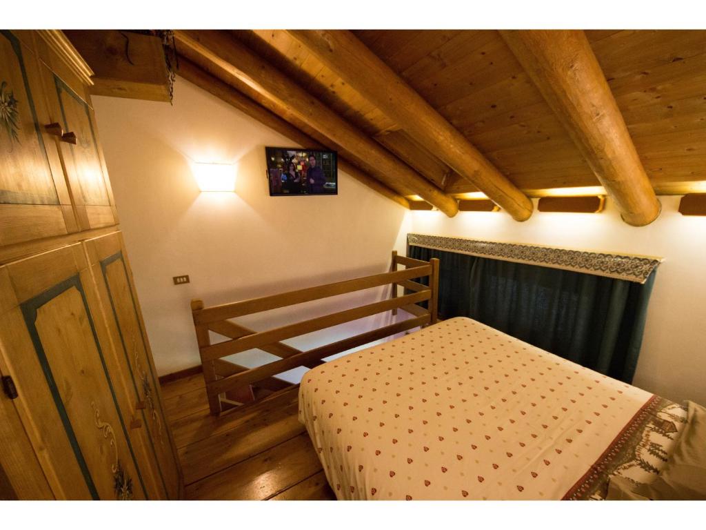 Кровать или кровати в номере Cristallo & Faloria Suite Apartments