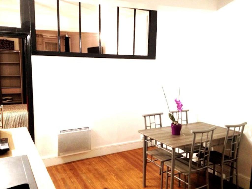 a kitchen and dining room with a table and chairs at lodge in Pont-sur-Seine