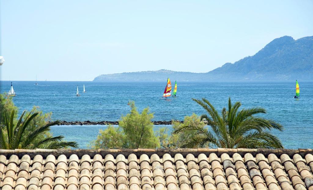 a view of the ocean with sail boats in the water at Apartamentos Sivella in Port de Pollensa