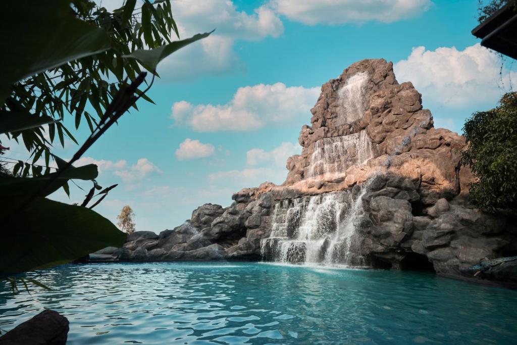 a waterfall in the middle of a pool of water at MJ Avyanna Resort & Convention Centre, Bengaluru in Bangalore