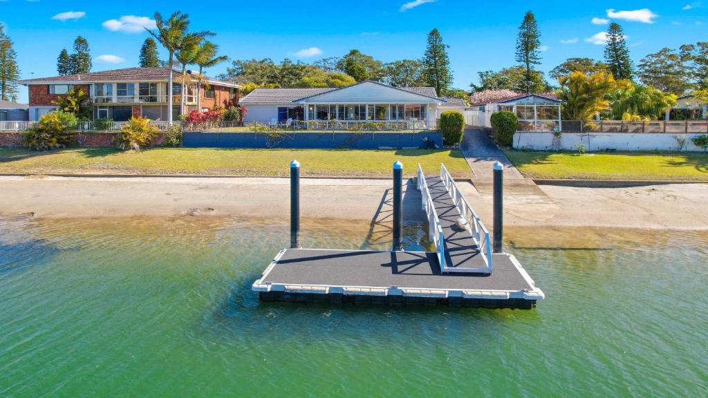 a playground in the water in front of a house at Hibbard Waterfront Escape in Port Macquarie
