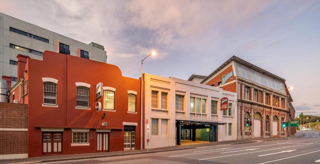 a group of buildings on a city street at The Old Woolstore Apartment Hotel in Hobart