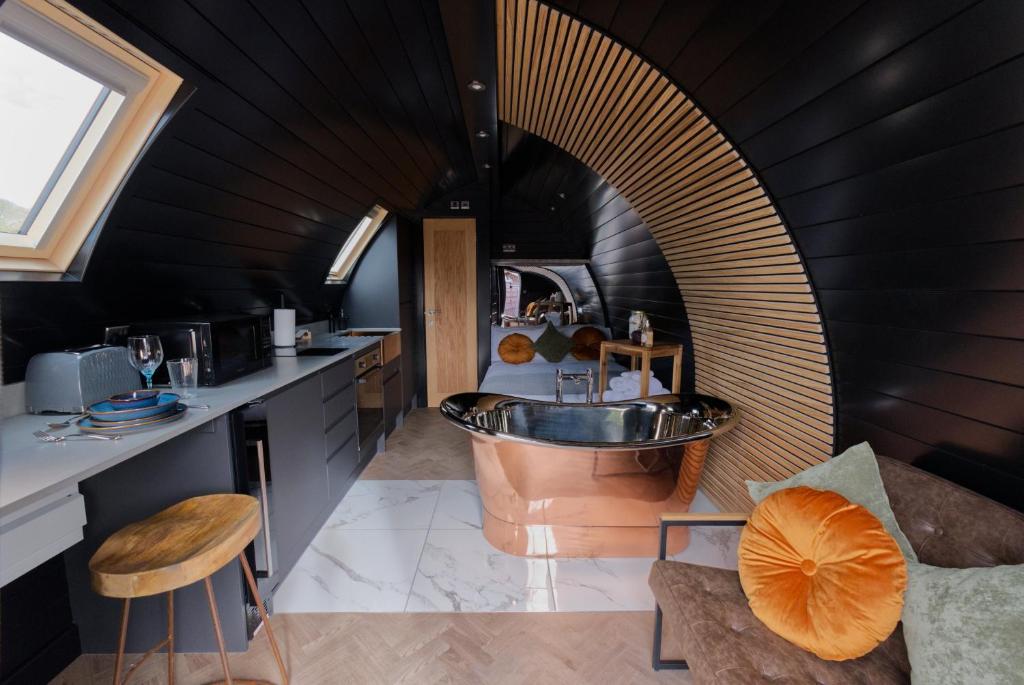 a bathroom with a tub and a sink in a room at North Coast 500 Pods in Achmelvich