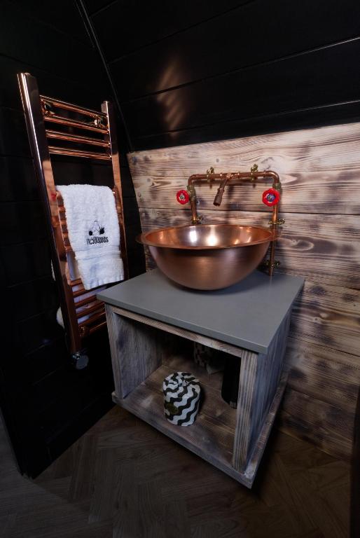 a bathroom with a bowl sink on a table at North Coast 500 Pods in Achmelvich