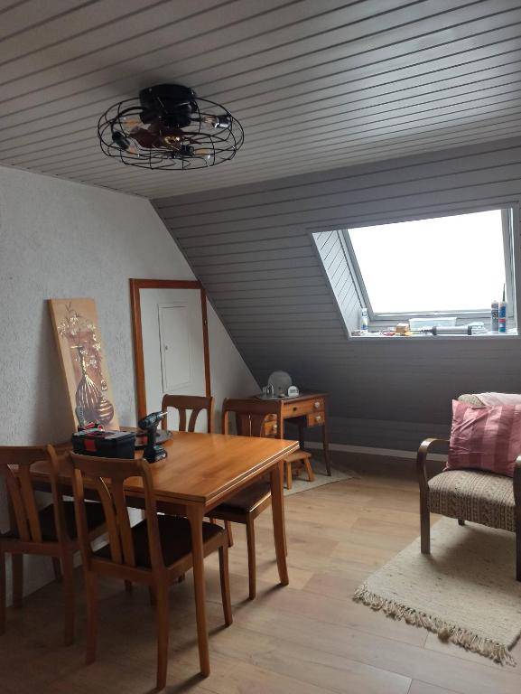 a dining room with a table and chairs and a window at Ferienhaus Dinger in Rüssingen