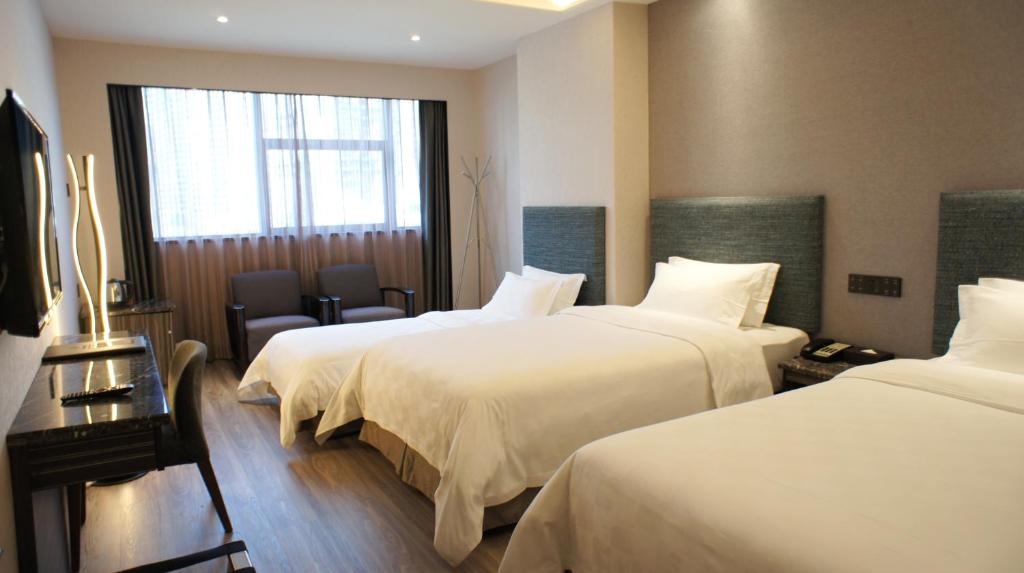 Postel nebo postele na pokoji v ubytování Shenzhen Lido Hotel