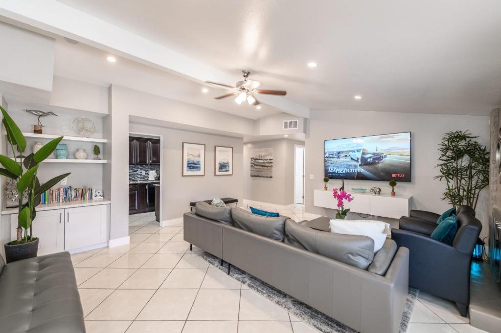 a living room with a couch and a tv at Disneyland Dream Villa 5 Bedroom 3 Bath Theater Games Pool Table in Anaheim