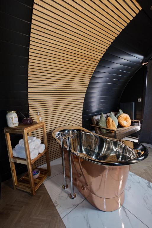 a bathroom with a copper tub in a room at North Coast 500 Pods in Achmelvich