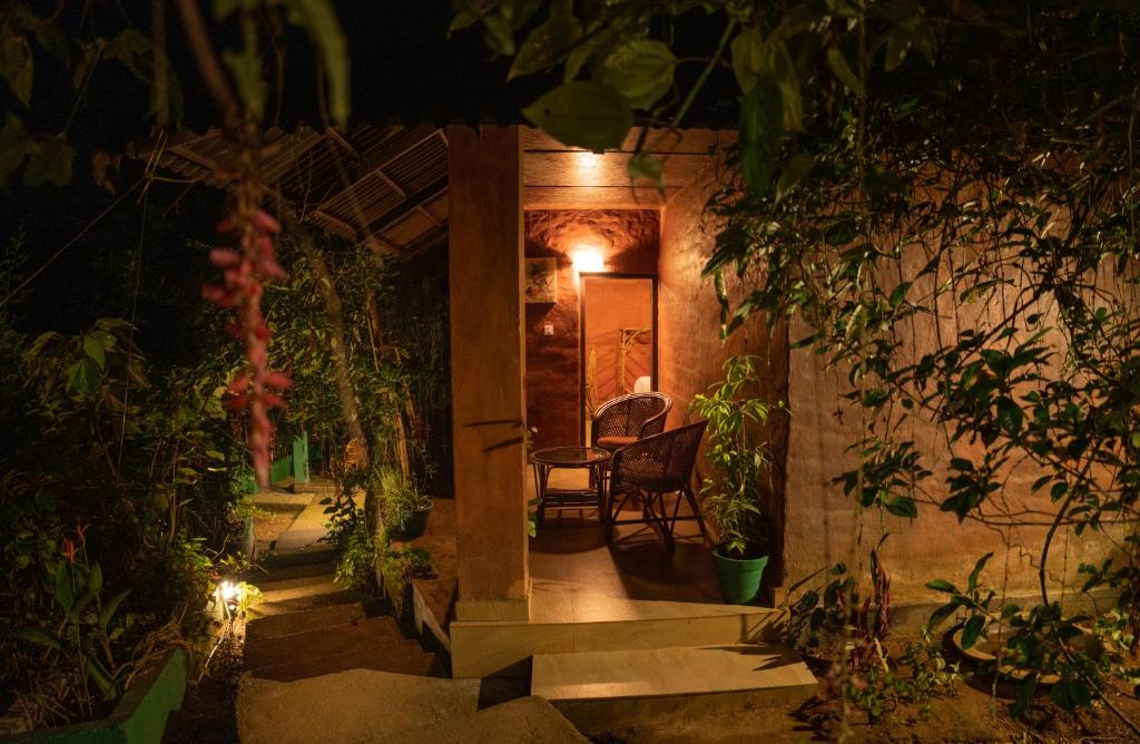 a house with a hallway with a table and chairs at Edens Munnar in Munnar