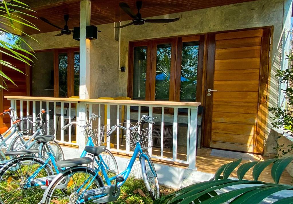 two bikes parked on the porch of a house at Malai Maikhao Near Beach in Ban Mai Salae