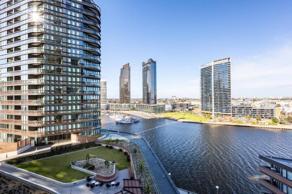 a view of a river in a city with tall buildings at Resort-style Docklands Riverview Stay with Parking in Melbourne