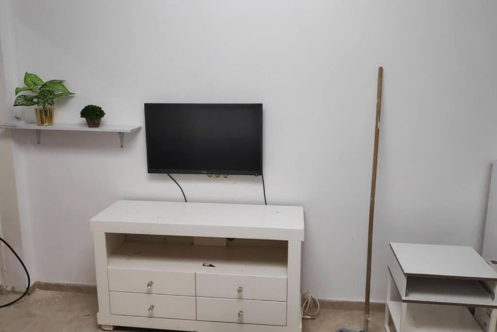 a flat screen tv sitting on top of a white cabinet at דירה פרטית מהממת מוארת. ממוזגת מרוהטת ומקסימה in Beer Sheva