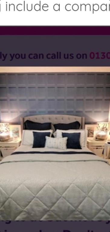 a bedroom with a bed with a sign that says you can call us on o at Sunningdale in Conisbrough