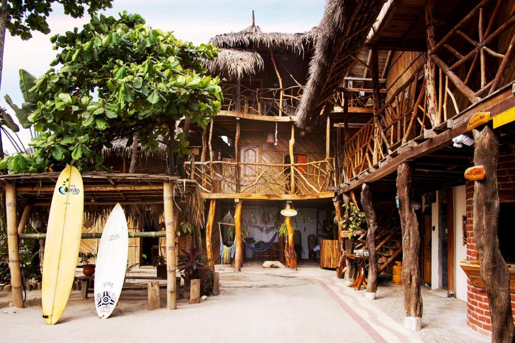 two surfboards are standing in front of a building at Hostal Olmito Canoa in Canoa