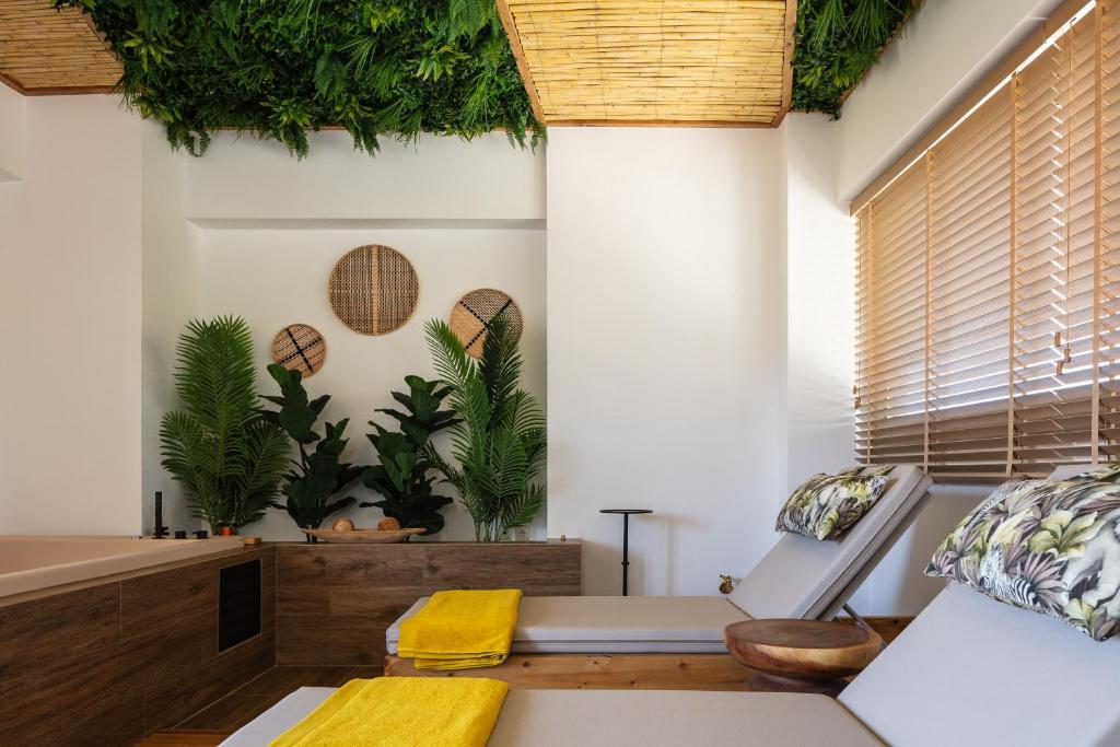a living room with plants on the wall at JW luxury apartment in Chania