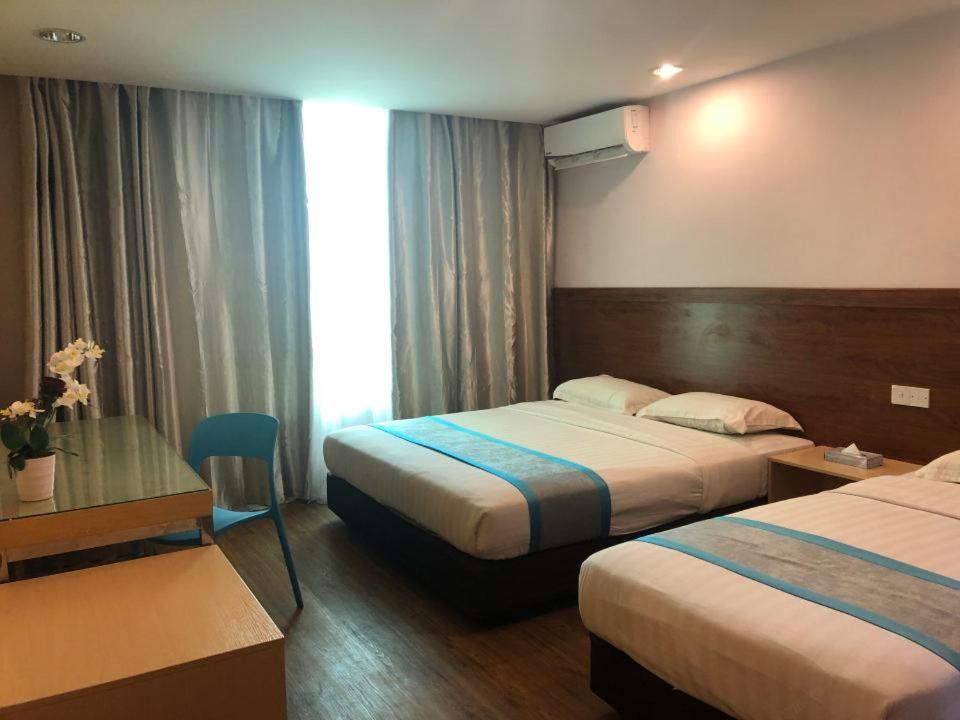 Postel nebo postele na pokoji v ubytování TD Mutiara Hotel Semporna