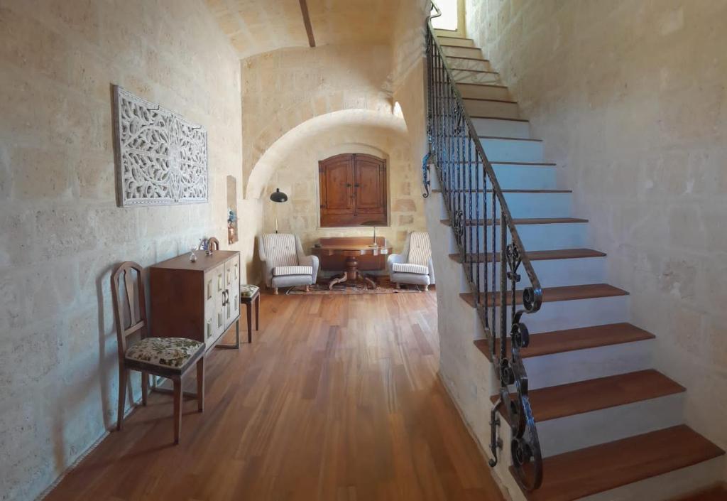 a hallway with a spiral staircase in a house at La Commenda di Picciano - Country House in Matera