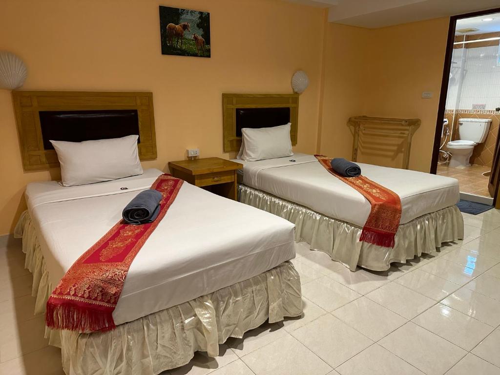 Postel nebo postele na pokoji v ubytování Nid Huahin Hotel
