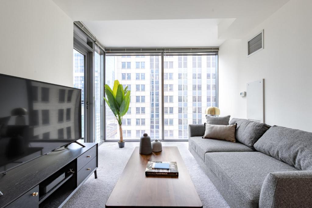 a living room with a couch and a tv at Loop 1BR w Gym Pool nr Financial District CHI-232 in Chicago