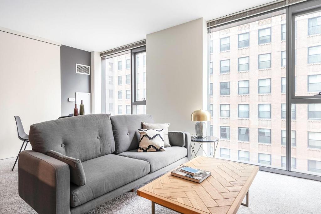 a living room with a couch and a table at Loop 1BR w Gym Pool WD nr Financial District CHI-238 in Chicago