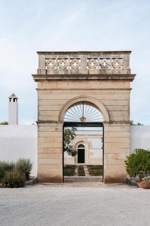 a stone archway with an entrance to a building at Masseria Gorgognolo in Ostuni