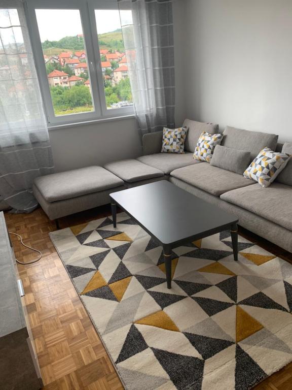 a living room with a couch and a coffee table at Apartment DELS in Zenica