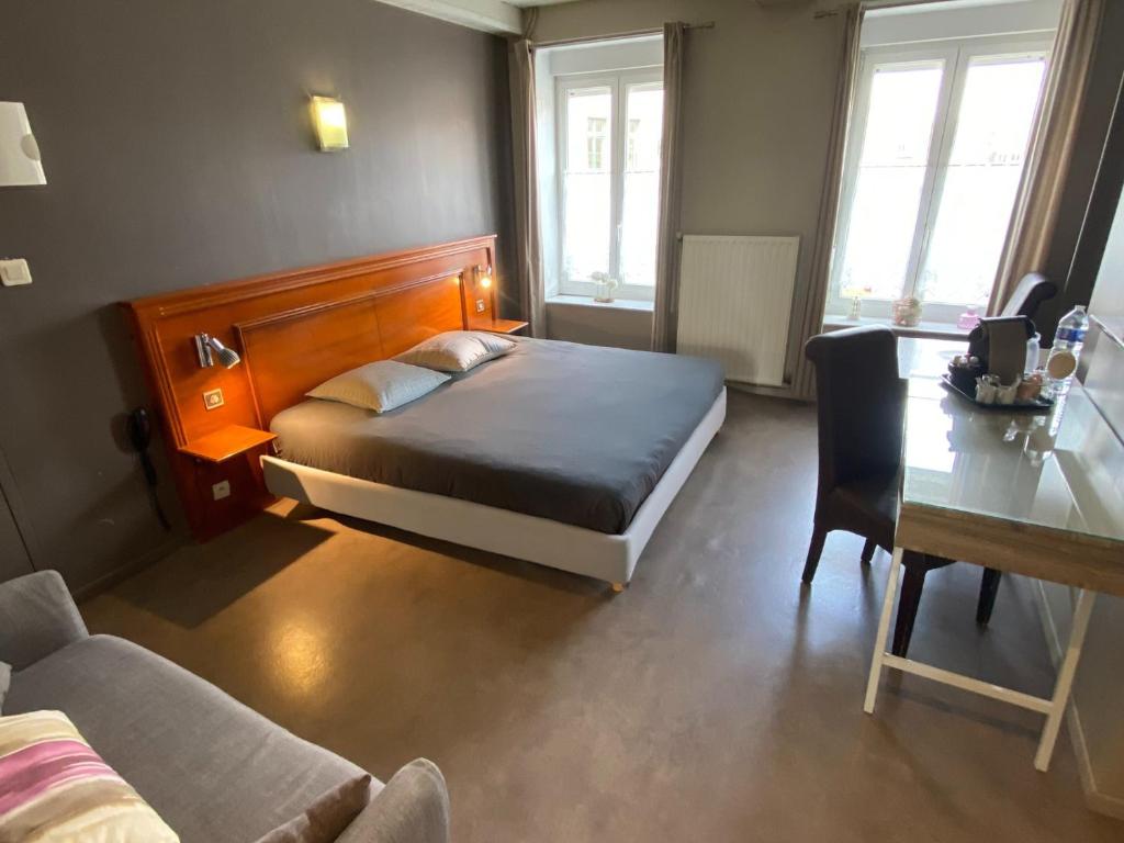 Een bed of bedden in een kamer bij Le Gîte des Voyageurs