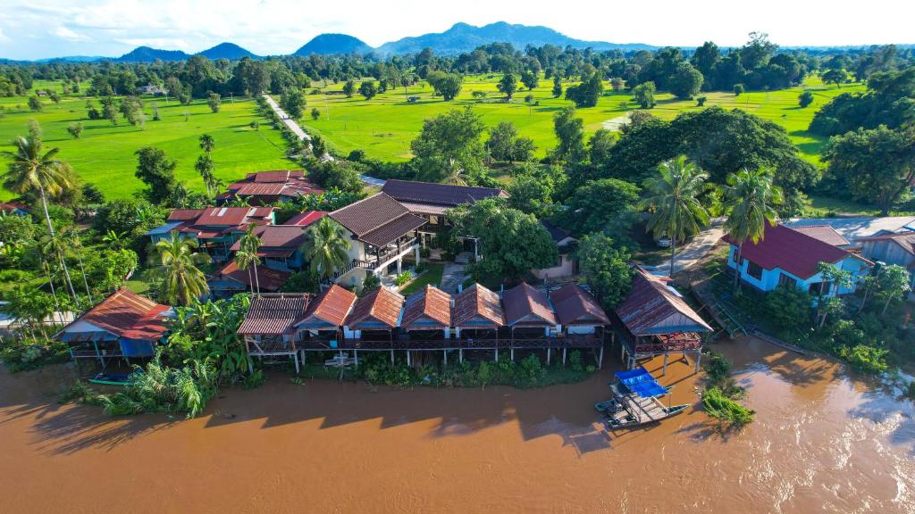 an aerial view of a resort on the river at Mr Tho's Bungalows in Don Det