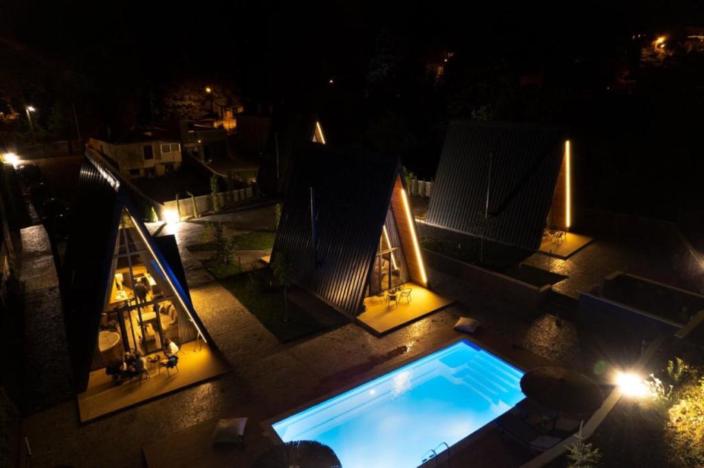 an overhead view of a swimming pool at night at Pavliani4rest - Luxury Cabins in Pavliani